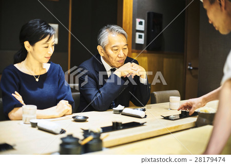 A couple enjoying sushi 28179474