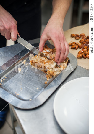 Cropped shot of male hands with strudel. Cropped shot of male hands with strudel. 28185330