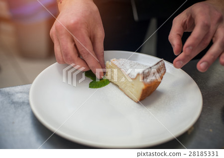 Dessert decoration: sweet tasty pie with mint leaf Dessert decoration: sweet tasty pie with mint leaf 28185331
