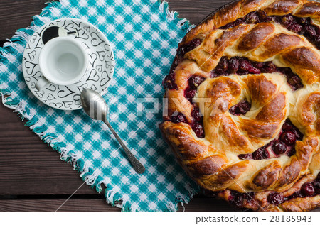 Homemade pie with cherries on wooden table. Homemade pie with cherries on wooden table. 28185943