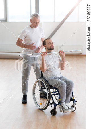 Involved aged physical therapist teaching the 28186317