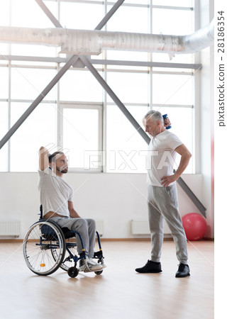 Athletic coach training the disabled young man in Athletic coach training the disabled young man in 28186354