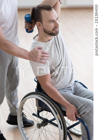 Involved young disabled man exercising in the gym 28186400