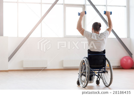Hardworking invalid exercising with weights in the 28186435
