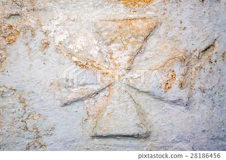 Maltese cross on stone wall Maltese cross on stone wall 28186456