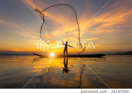 Silhouette of Myanmar fisherman on wooden boat 28187089
