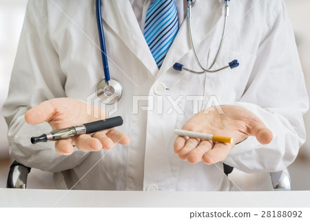 Doctor is comparing vaporizer and cigarette. Doctor is comparing vaporizer and cigarette. 28188092