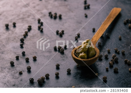 Vintage wooden spoon with capers on dark tray Vintage wooden spoon with capers on dark tray 28193408