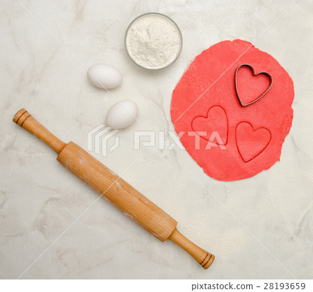 Red dough with a cut out heart, eggs, flour Red dough with a cut out heart, eggs, flour 28193659