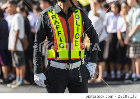 Traffic police standing on the road while doing the work Traffic police standing on the road while doing the work 28198138