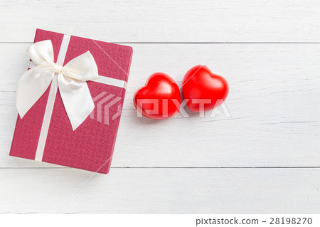 Top view red heart and gift box with ribbon on white wooden plank. For love or valentine day concept 28198270