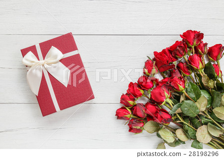 Fresh red rose flower and gift box on white wooden deck with empty space for design. For love or valentine day concept 28198296