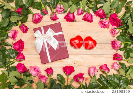 Fresh pink rose flower and gift box on wooden deck. For love or valentine day concept Fresh pink rose flower and gift box on wooden deck. For love or valentine day concept 28198309