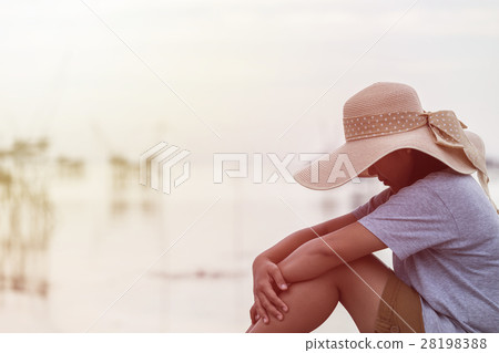 Backside of woman with big hat on the bridge and sunrise Backside of woman with big hat on the bridge and sunrise 28198388