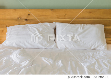 White bedding sheets and pillow on wooden wall room background, Messy bed concept White bedding sheets and pillow on wooden wall room background, Messy bed concept 28198402