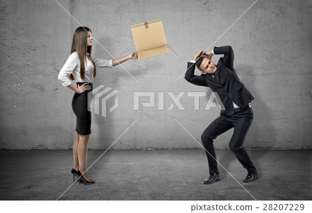 Businesswoman on concrete background holding a Businesswoman on concrete background holding a 28207229