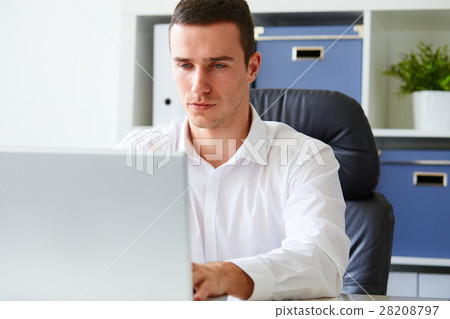 Man in a polo shirt stands leaning on railing Man in a polo shirt stands leaning on railing 28208797