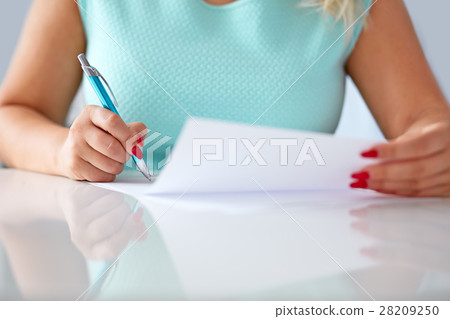 Young woman signs a contract 28209250