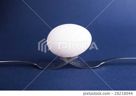 An egg on spoon isolated on blue background 28218044
