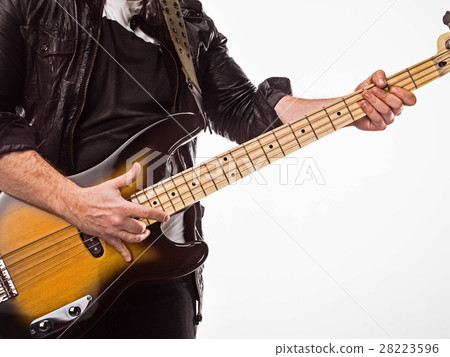 Bassist plays bass guitar. 28223596