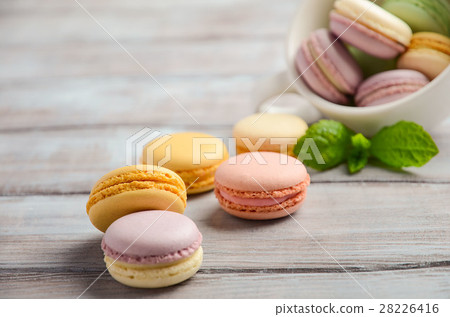 Colorful French macaroons on wooden background. Colorful French macaroons on wooden background. 28226416