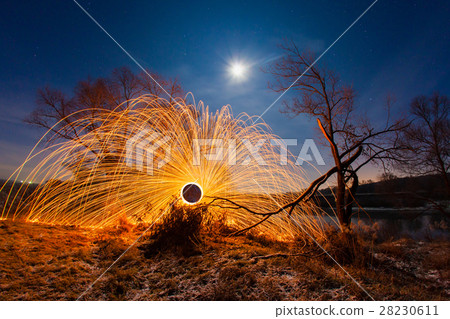 Burning sparks in the night winter landscape Burning sparks in the night winter landscape 28230611