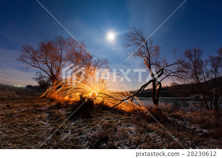 Burning sparks in the night winter landscape Burning sparks in the night winter landscape 28230612