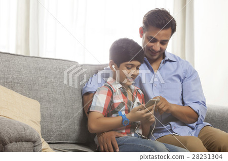 Father and son listening to music Father and son listening to music 28231304