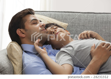 Father and son sleeping on sofa 28231312