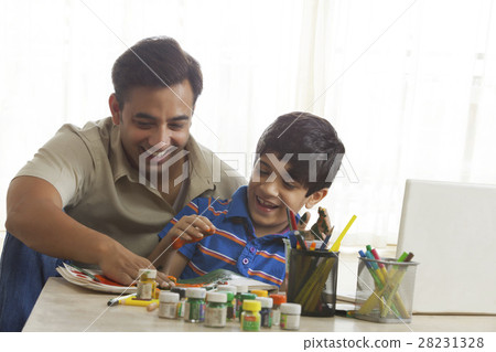 Father and son finger painting together 28231328