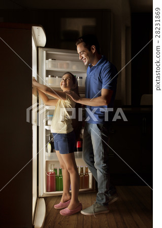 Father and daughter searching food in fridge at night 28231869