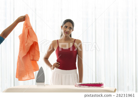 Bored woman avoiding ironing Bored woman avoiding ironing 28231961