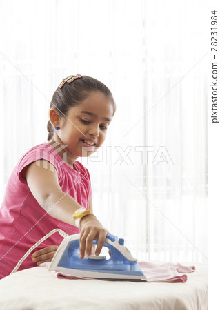 Smiling girl ironing Smiling girl ironing 28231984
