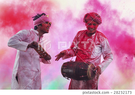 Two Young Indian men With Colored Face Dancing During Holi Color festival Two Young Indian men With Colored Face Dancing During Holi Color festival 28232173