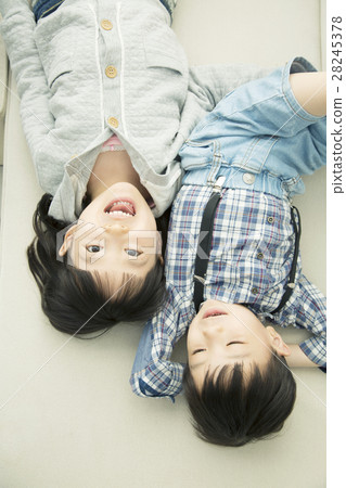 Brothers lying down on the carpet 28245378