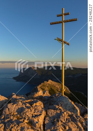 Orthodox cross at sunrise on top of mountain Ilyas Orthodox cross at sunrise on top of mountain Ilyas 28246227