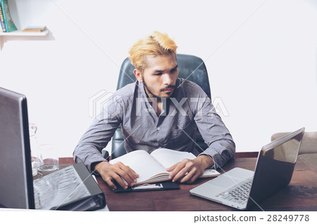 Handsome bearded man sitting at desk. serious expression 28249778