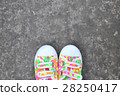 Colorful Sneakers on Gray Asphalt Road 28250417