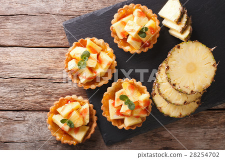 Delicious tartlets with fresh pineapple and jam Delicious tartlets with fresh pineapple and jam 28254702