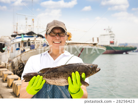 happy fisherman showing  fish before fishing ship 28256423