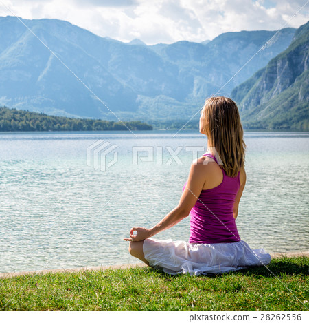 Woman meditating at the lake Woman meditating at the lake 28262556