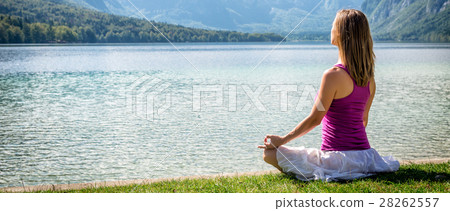 Woman meditating at the lake Woman meditating at the lake 28262557