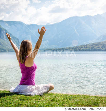 Woman meditating at the lake Woman meditating at the lake 28262558