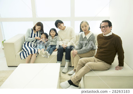 Three generations family with a smile sitting on the sofa Three generations family with a smile sitting on the sofa 28263183