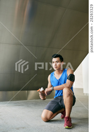 Asian sportsman sitting on haunches Asian sportsman sitting on haunches 28263329