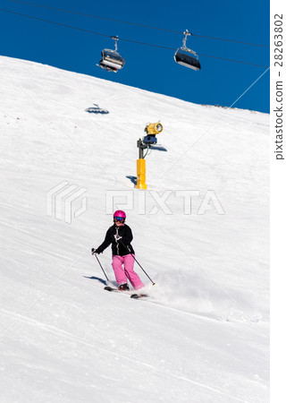 Female skier in fresh powder snow and blue sky 28263802