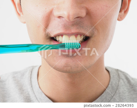 A young man brushing a tooth A young man brushing a tooth 28264393