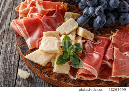 Prosciutto, wine, grape, parmesan on wooden table. 28265099