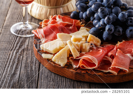 Prosciutto, wine, grape, parmesan on wooden table. 28265101