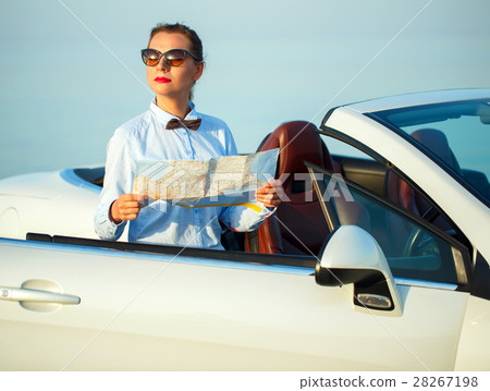 Young pretty woman see the map near the cabriolet Young pretty woman see the map near the cabriolet 28267198
